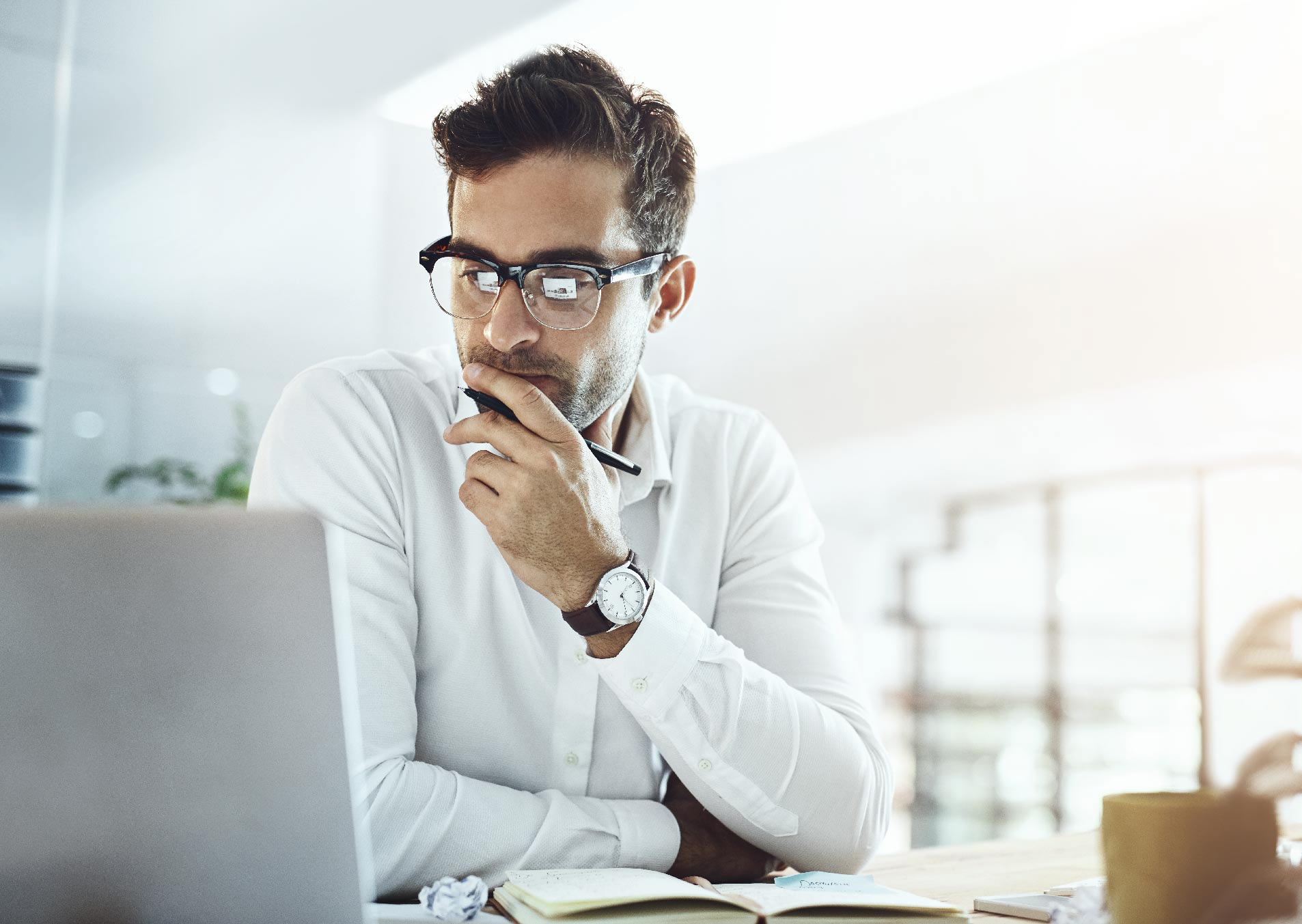 Man looking pensively at laptop screen